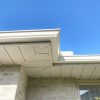 Seamless gutters installed professionally looking from below against blue sky