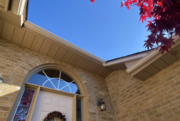 View of soffit & Fascia installation from below against bright blue sky