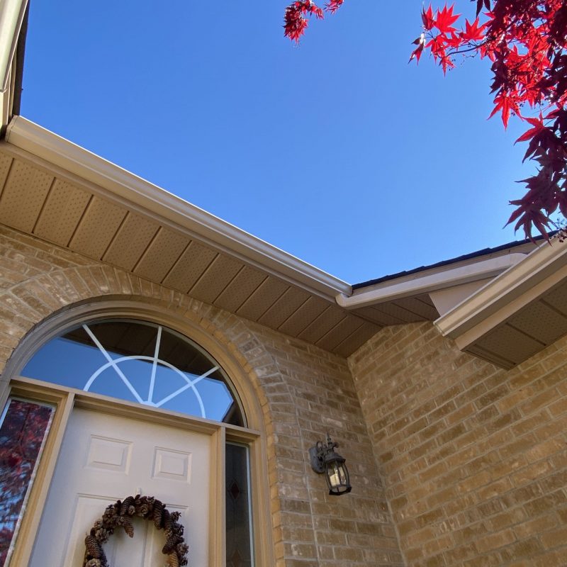 View of soffit & Fascia installation from below against bright blue sky