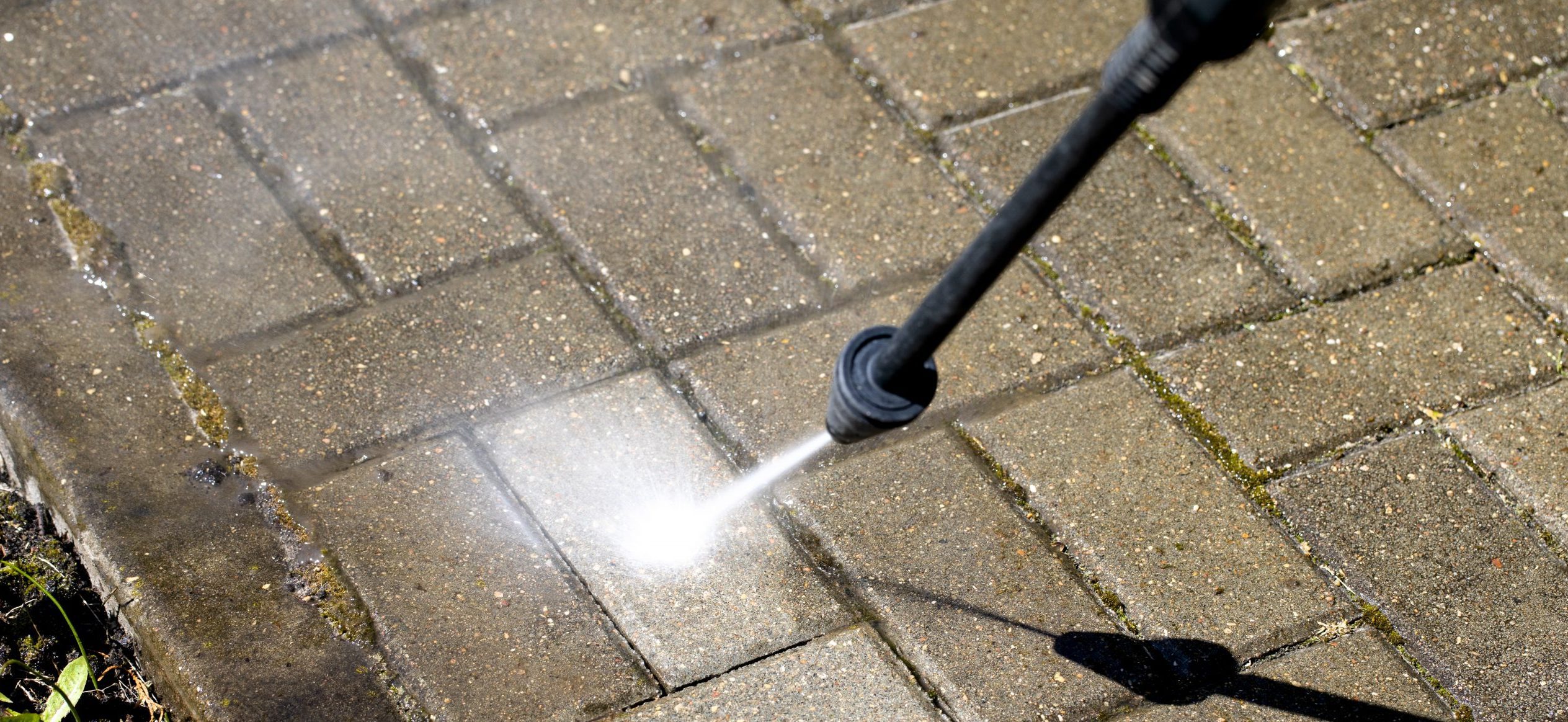 high-pressure washer cleans with jet of water concrete stones