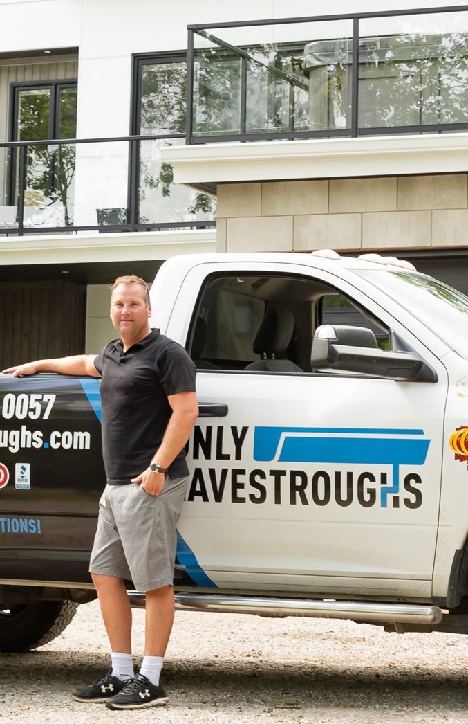 michael okane in front of only eavestroughs truck