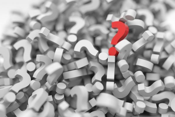 Pile of white 3D question marks with one red one